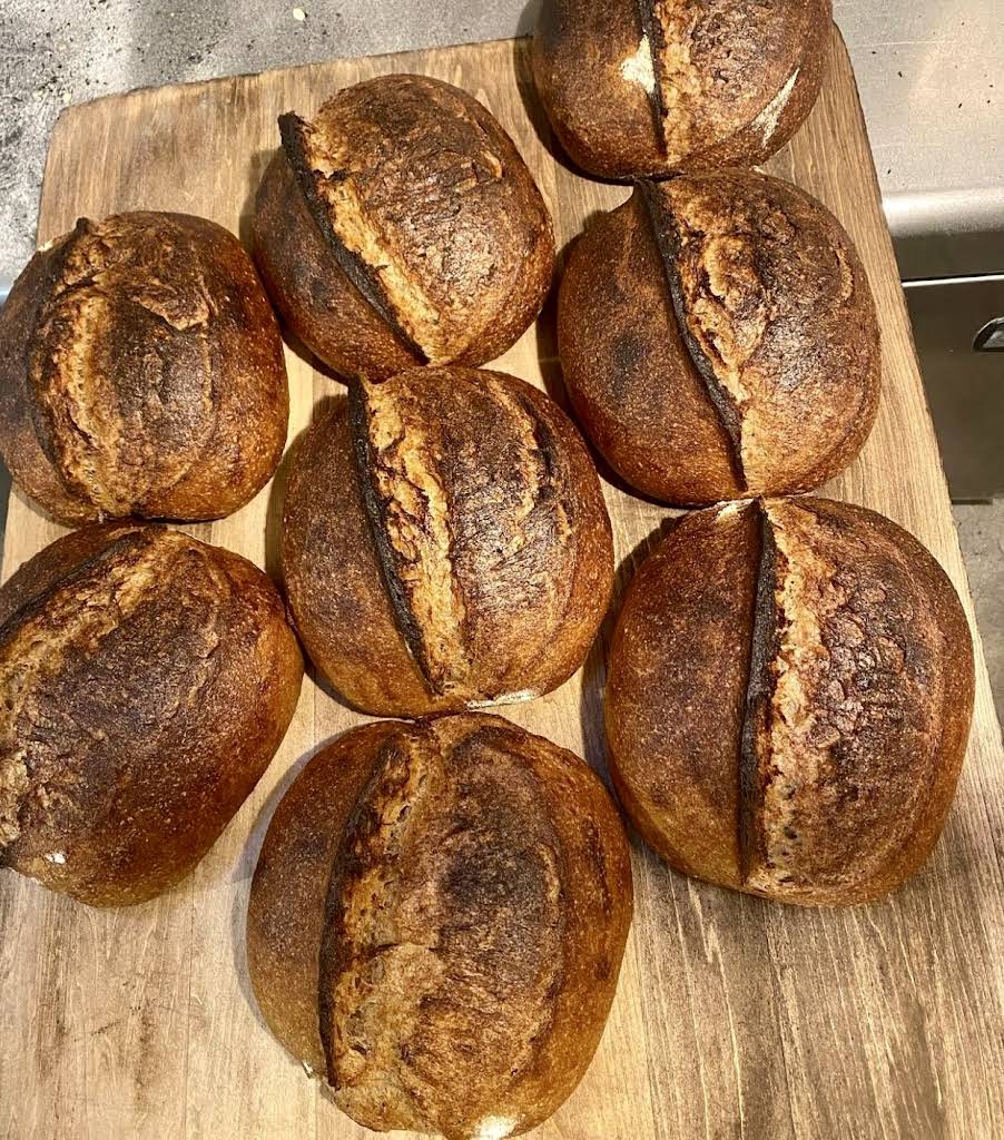 Sourdough loaves cooling on a rack